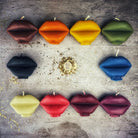 Red beeswax candle shaped like lips, designed for communication and passion magic, from Parlour of Wonders.