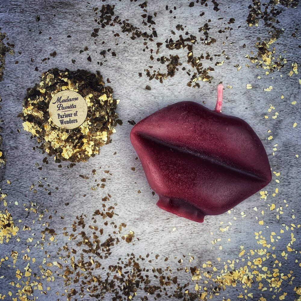 Red beeswax candle shaped like lips, perfect for communication and passion magic, with "Talk to Me" inscription by Parlour of Wonders.