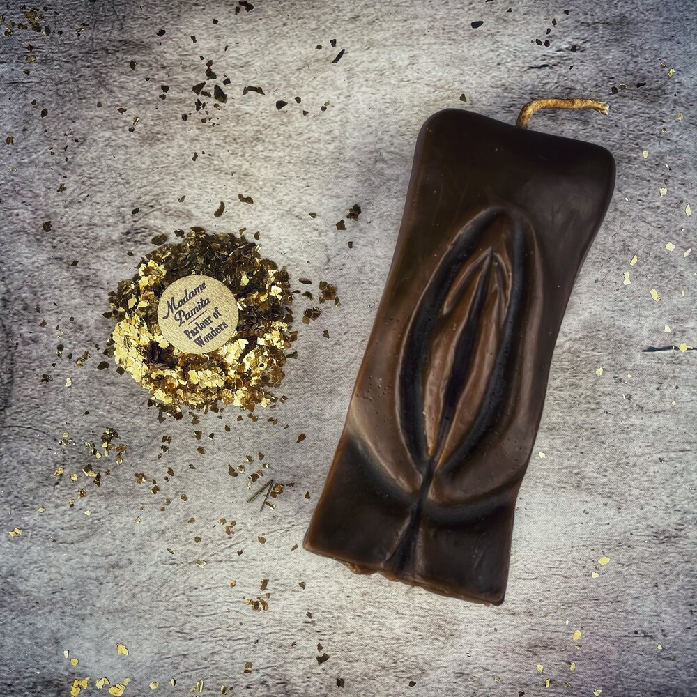 Red beeswax yoni vulva spell candle by Parlour of Wonders for passionate love and sex magic, featuring a detailed vulva design.