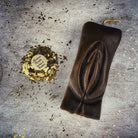 Red beeswax yoni vulva spell candle by Parlour of Wonders for passionate love and sex magic, featuring a detailed vulva design.