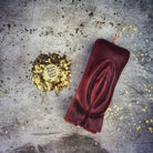 Red beeswax Yoni vulva spell candle from Parlour of Wonders, designed for passionate love and sex magic rituals.
