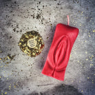 Red beeswax yoni vulva spell candle by Parlour of Wonders, designed for passionate love and sex magic rituals.