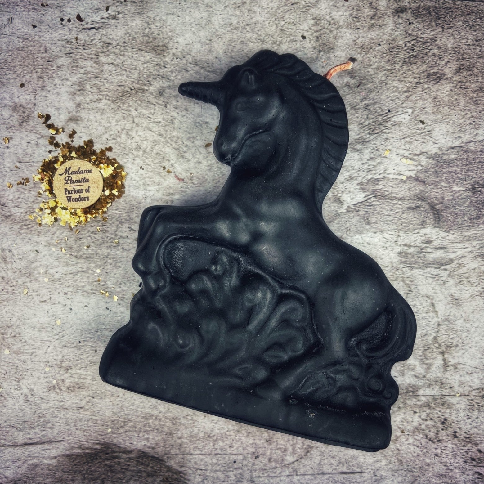 White beeswax unicorn spell candle by Parlour of Wonders for manifestation and wishes magic, featuring intricate unicorn design.
