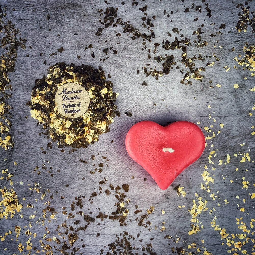 White beeswax mini heart candle from Parlour of Wonders, used for love influence and emotional healing magic.
