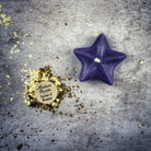 White beeswax Sister Star Spell Candle by Parlour of Wonders for protection and spiritual power magic, featuring a star-shaped design.
