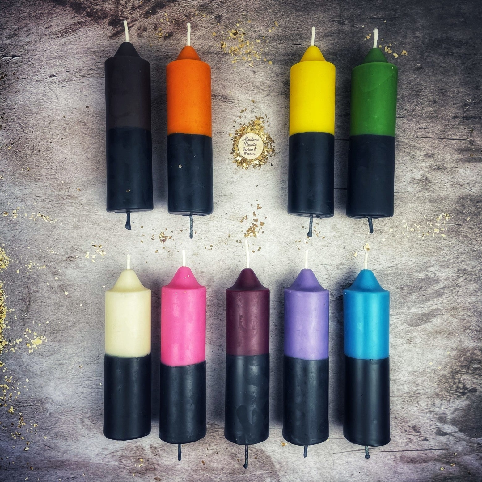 Yellow and black beeswax candle with double action design for protection and curse reversal, from Parlour of Wonders.