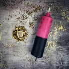 Yellow and black beeswax candle from Parlour of Wonders for protection and curse reversal magic, featuring double-action reversing spell design.