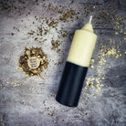 Beeswax double action reversing spell candle with yellow and black wax, used for protection and curse reversal magic.