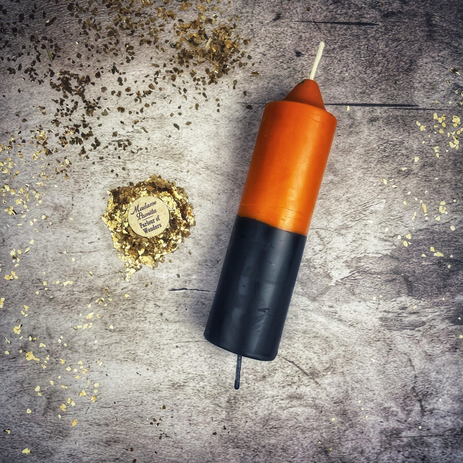 Yellow and black beeswax double action reversing spell candle by Parlour of Wonders, used for protection and curse reversal magic.