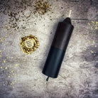 Yellow and black beeswax candle from Parlour of Wonders, designed for protection and curse reversal magic.
