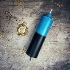 Yellow and black beeswax double action reversing spell candle by Parlour of Wonders for protection and curse reversal magic.