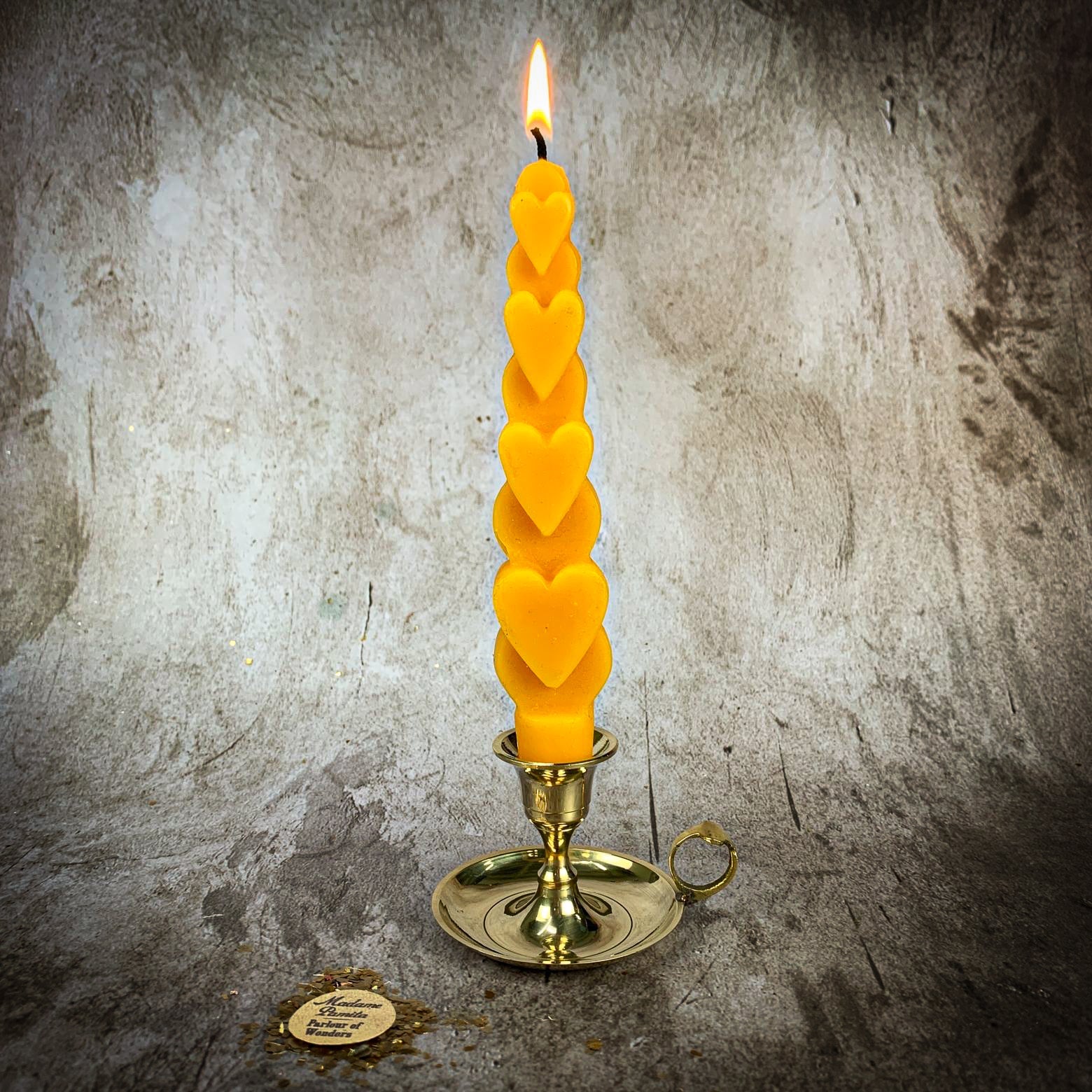 Yellow beeswax love spell heart taper candle by Parlour of Wonders, used for romance and attraction magic.