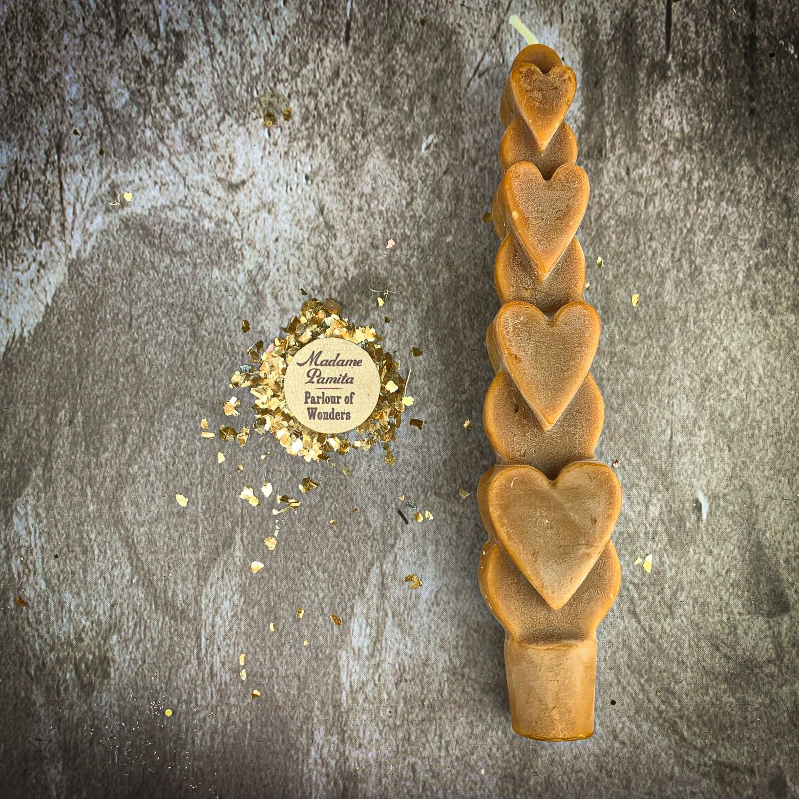 Yellow beeswax love spell heart taper candle by Parlour of Wonders, symbolizing romance and attraction magic.
