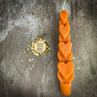 Yellow beeswax love spell heart taper candle by Parlour of Wonders, symbolizing romance and attraction magic.