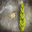 Yellow beeswax love spell heart taper candle by Parlour of Wonders, used for romance and attraction magic.
