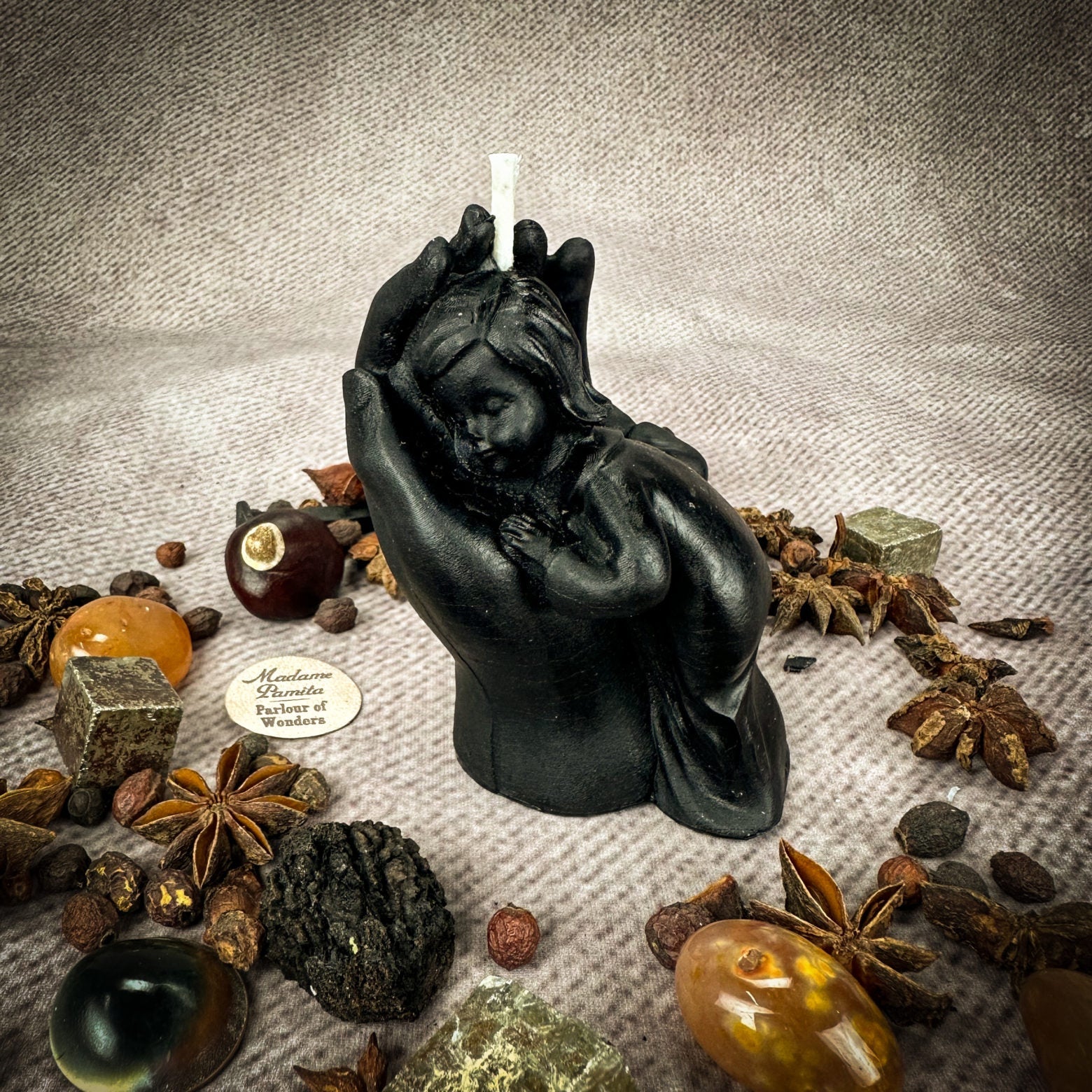 Yellow beeswax candle with a mother and child design, symbolizing protection, fertility, and family blessings, by Parlour of Wonders.