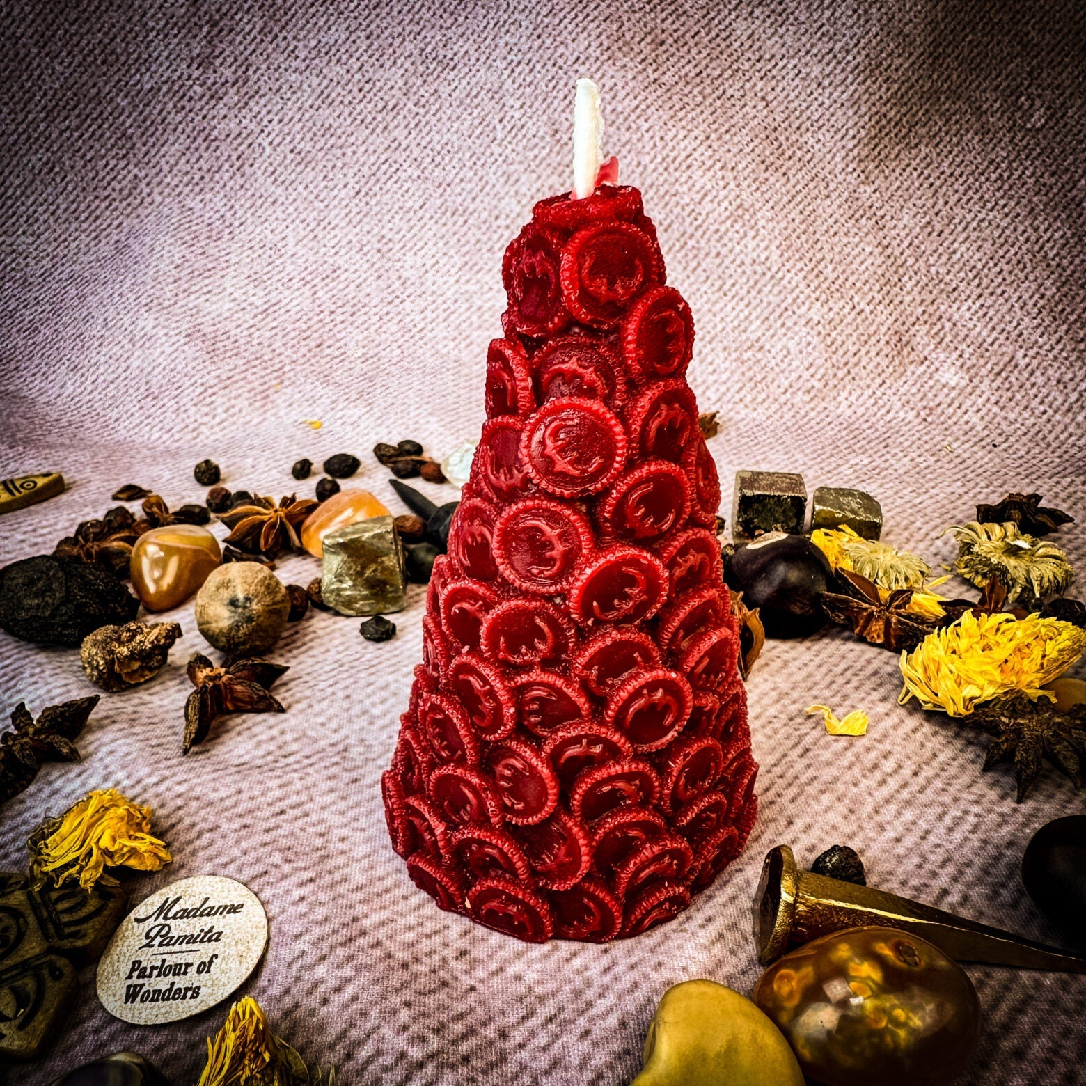 Yellow beeswax cone of coins spell candle by Parlour of Wonders, designed to attract money and prosperity magic.