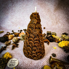 Yellow beeswax cone of coins spell candle by Parlour of Wonders, designed as a money magnet and prosperity magic candle.