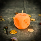 Yellow beeswax candle with lucky dice design, promoting gambling luck and good fortune, by Parlour of Wonders.