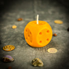 Yellow beeswax candle with lucky dice design by Parlour of Wonders, symbolizing gambling luck and good fortune.
