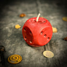 Yellow beeswax candle with dice design, promoting gambling luck and good fortune, from Parlour of Wonders.