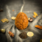 Yellow beeswax nest egg spell candle from Parlour of Wonders, symbolizing savings and financial security.
