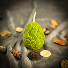 Yellow beeswax nest egg candle by Parlour of Wonders, symbolizing savings and financial security, with intricate design details.