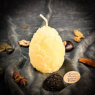 Yellow beeswax nest egg candle by Parlour of Wonders, designed for financial security and savings spells.