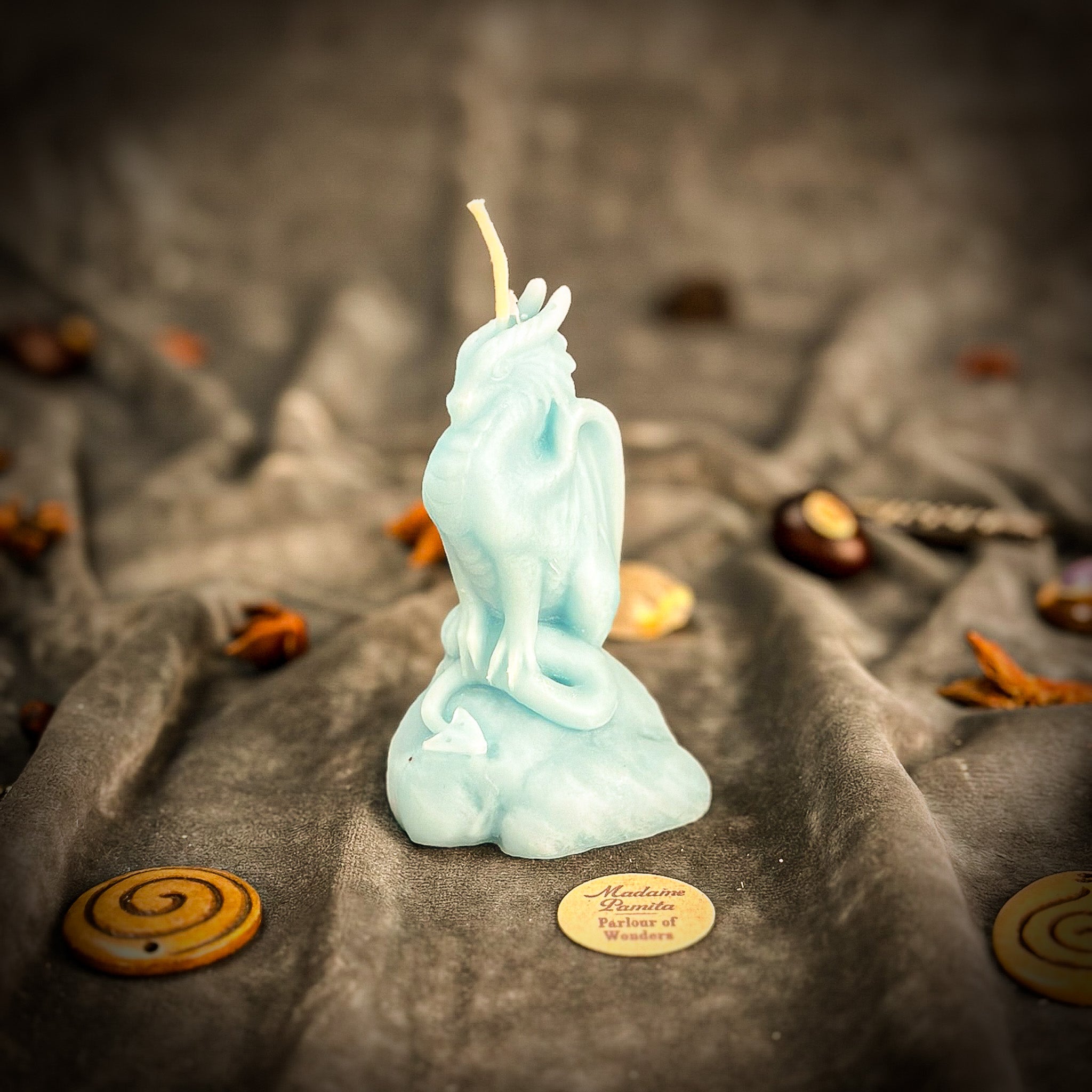 Yellow beeswax candle featuring a carved dragon design, symbolizing protection, power, and guardian magic from Parlour of Wonders.