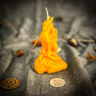 Yellow beeswax candle featuring a carved dragon design for protection, guardian magic, and defensive power.