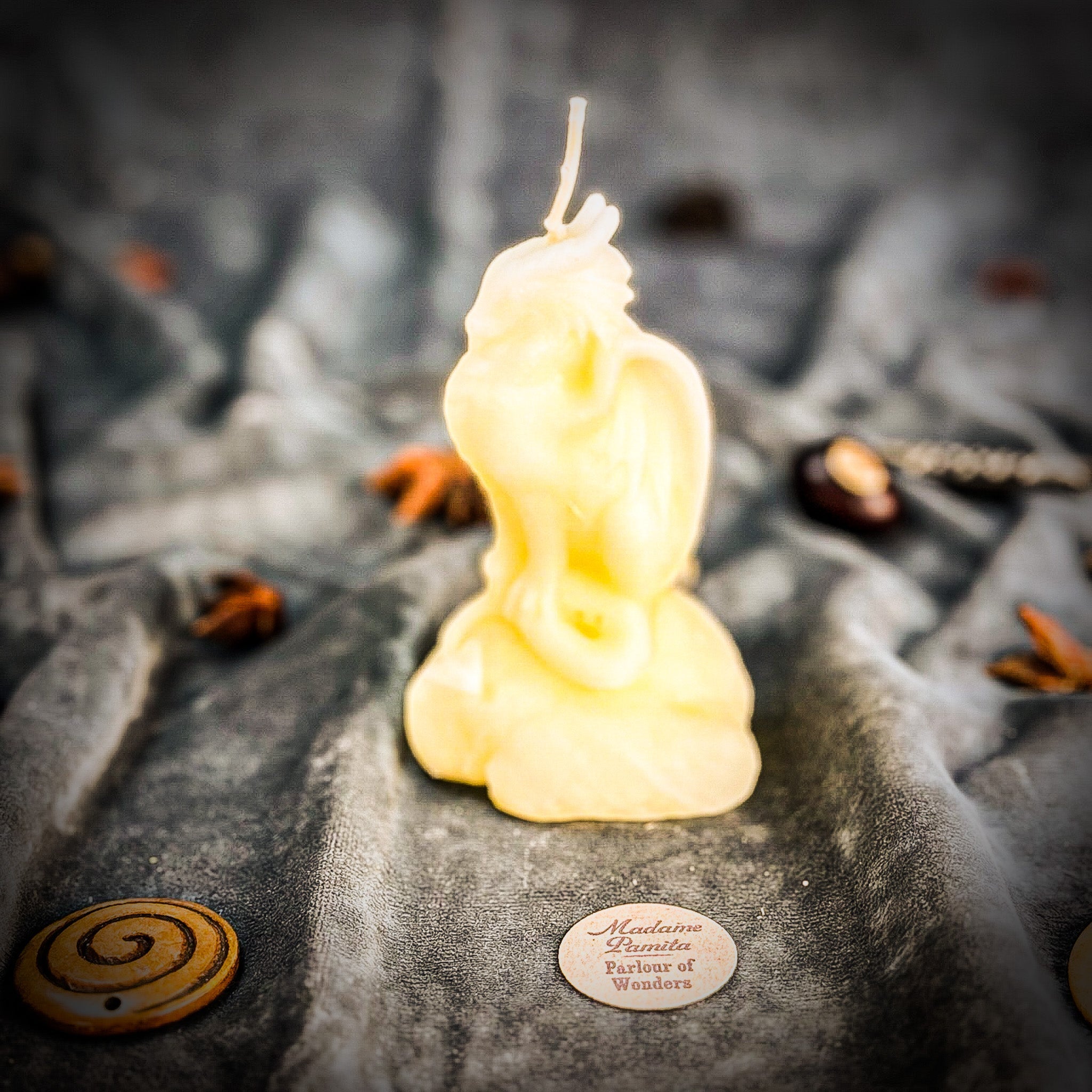 Yellow beeswax candle featuring a dragon design, symbolizing protection, guardian magic, and defensive power.
