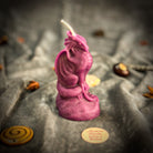 Yellow beeswax candle with a carved dragon design for protection, guardian magic, and defense by Parlour of Wonders.