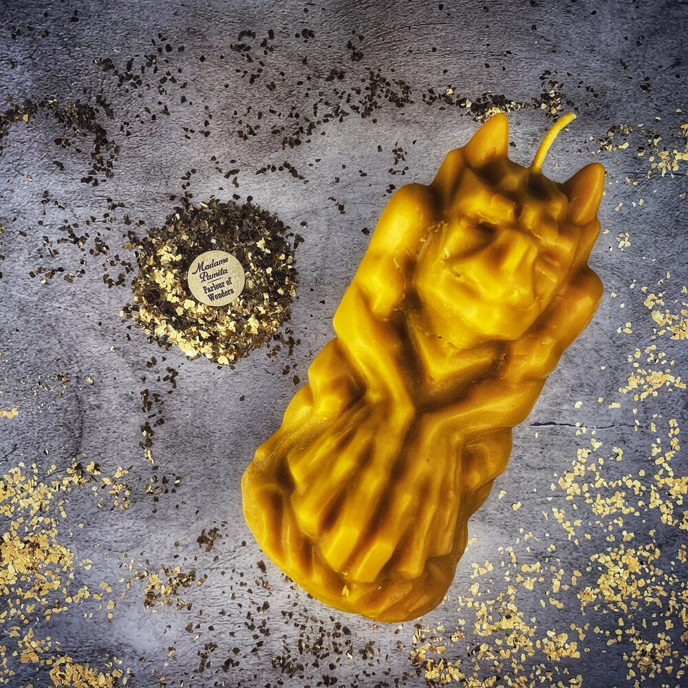 Yellow beeswax candle with a gargoyle protector design, used for guardian and protection magic by Parlour of Wonders.
