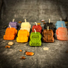 Yellow beeswax candle by Parlour of Wonders with charms for safe travels and vehicle protection, designed as a spell candle for travel safety.
