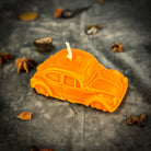 Yellow beeswax car spell candle from Parlour of Wonders with charms for safe travels and vehicle protection.