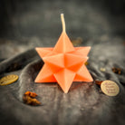 Yellow beeswax candle with pentagram and Merkaba symbols, used for protection, ascension, and sacred geometry rituals.