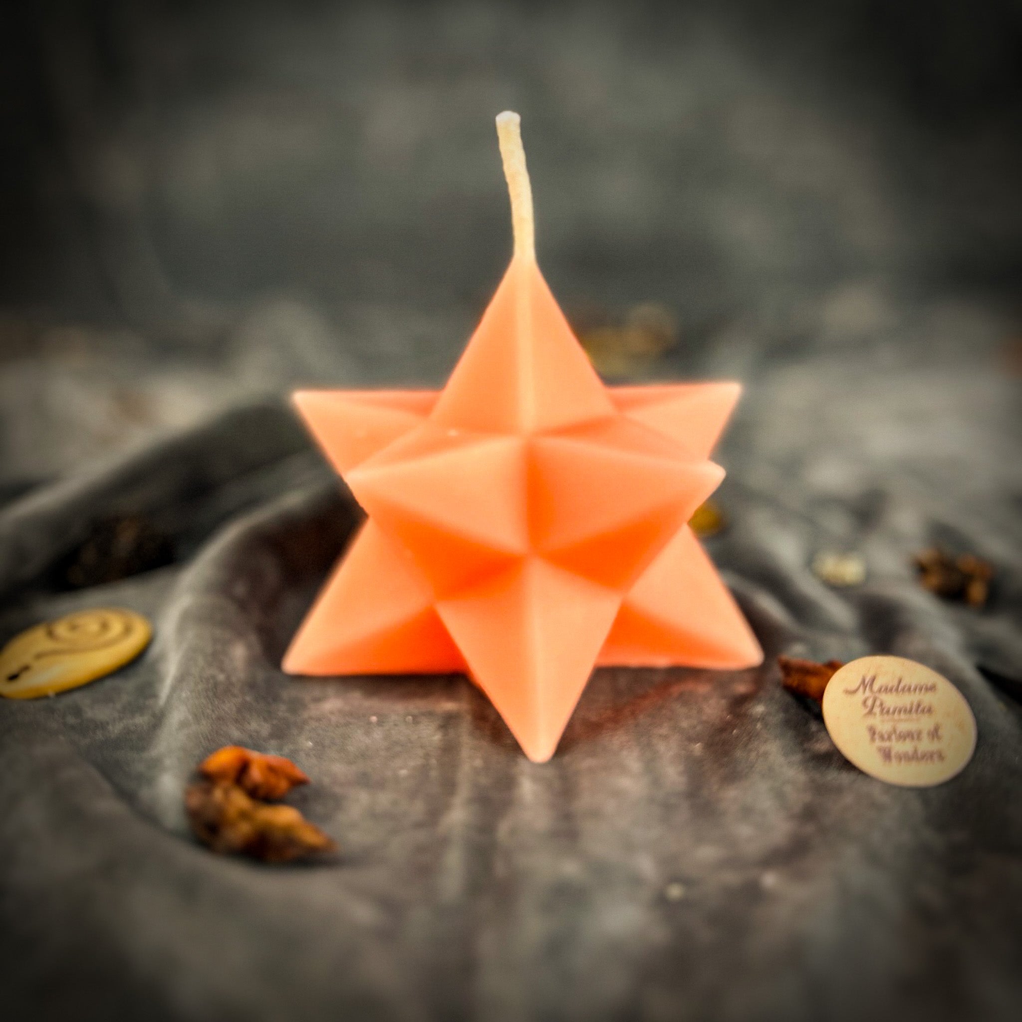 Yellow beeswax candle with pentagram and Merkaba symbols, used for protection, ascension, and sacred geometry rituals.