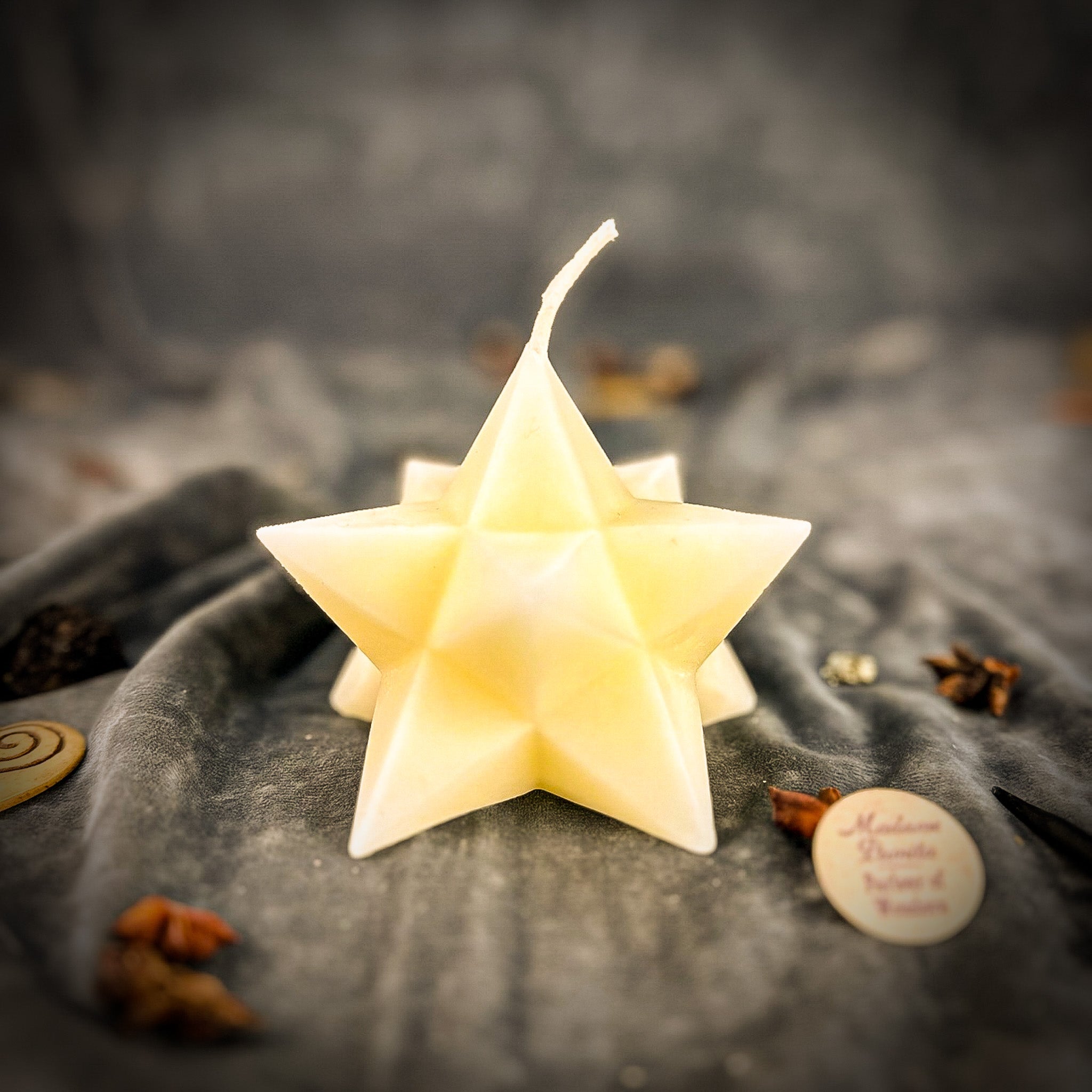 Yellow beeswax candle featuring a pentagram and Merkaba design, symbolizing protection, ascension, and sacred geometry.