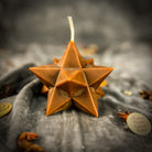 Yellow beeswax candle featuring a pentagram and merkaba design, representing protection, ascension, and sacred geometry.