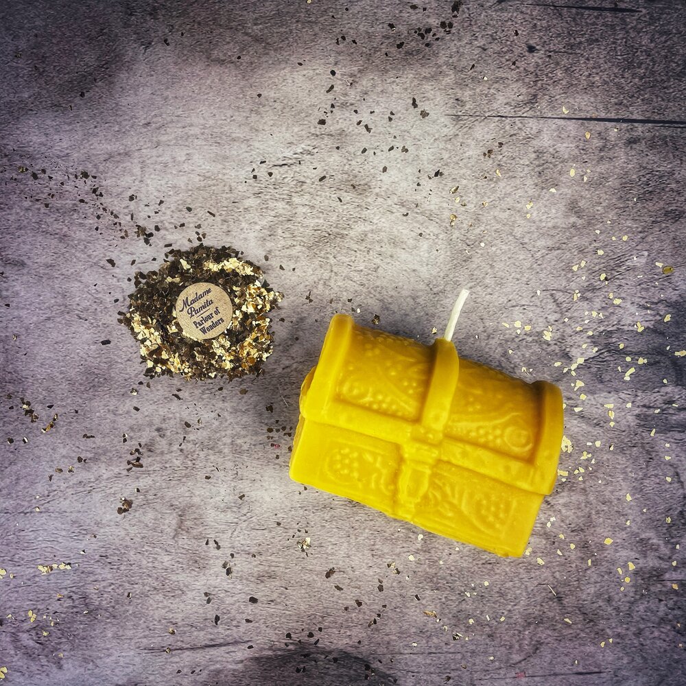 Yellow beeswax candle shaped like a treasure chest from Parlour of Wonders, used for blessings and abundance magic.
