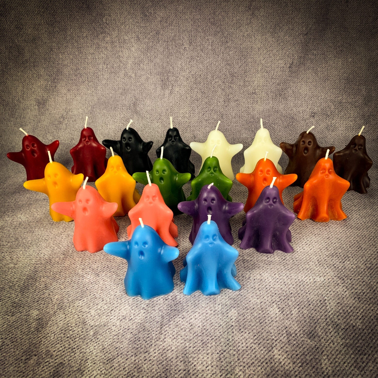 Set of yellow beeswax candles featuring wishing ghost designs for spirit guide and ancestor magic rituals.