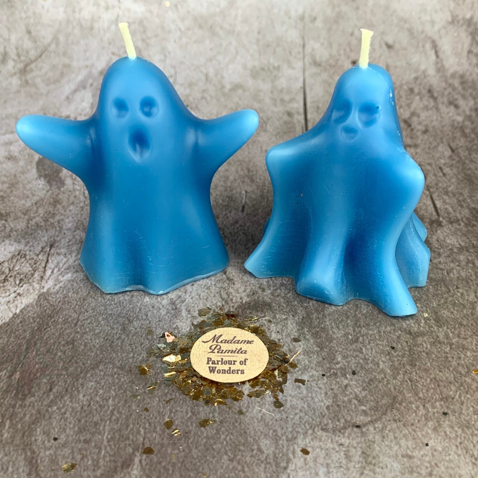 Set of yellow beeswax candles featuring ghost-shaped designs for spirit guide and ancestor magic rituals.