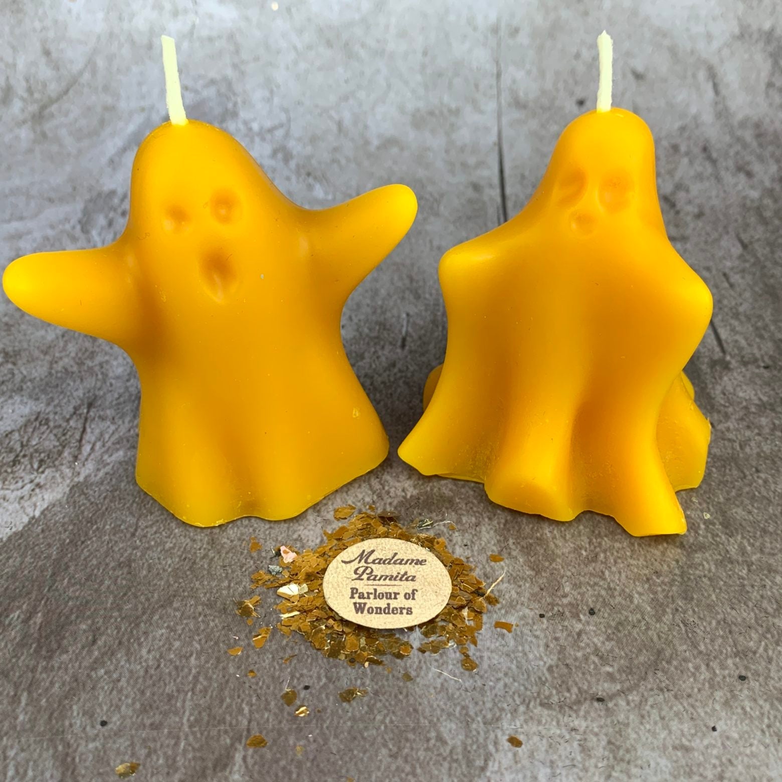 Set of yellow beeswax candles with ghost-shaped designs for spells, spirit guides, and ancestor magic by Parlour of Wonders.