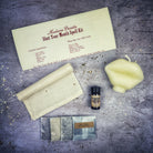 Black candle spell kit by Parlour of Wonders to stop gossip and silence rumors, featuring a firm sealing candle and spell tools.