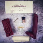 Black candle spell kit with yoni and phallus symbols for passion and attraction by Parlour of Wonders, designed for sex magick rituals.