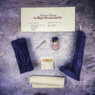 Black candle spell kit with yoni and phallus symbols, designed for passion and attraction magic, from Parlour of Wonders.