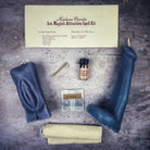 Black candle spell kit by Parlour of Wonders featuring yoni and phallus symbols for passion and attraction magic.