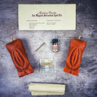 Black candle spell kit by Parlour of Wonders featuring yoni symbols for passion and desire magic.