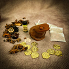 Lucky Money Frog Candle Spell Kit by Parlour of Wonders, featuring black candles and charms for abundance and prosperity.