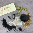 Parlour of Wonders Candle Spell Kit with black cauldron, herbs, and candles for transformation and positive change in magic rituals.